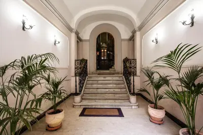 a hallway with stairs and potted plants at Diocleziano Triple in Rome