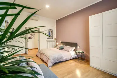 a bedroom with a bed and a potted plant at Diocleziano Triple in Rome