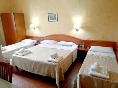 two beds in a hotel room with towels on them at Hotel Ferrari in Rome
