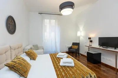 a bedroom with a white bed and a television at TIME in Rome