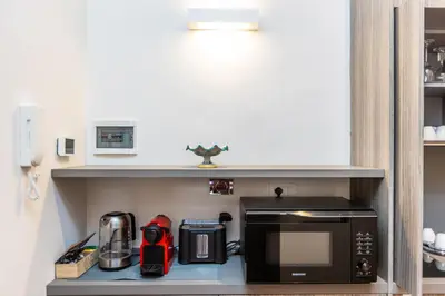 a kitchen with a counter with a microwave and a stove at TIME in Rome