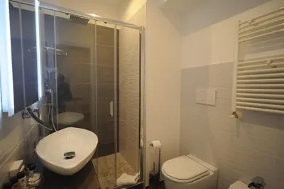 a bathroom with a toilet and a sink and a shower at My Suites Piazza di Spagna in Rome