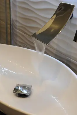 a silver item is being being watered by a metal practition at My Suites Piazza di Spagna in Rome