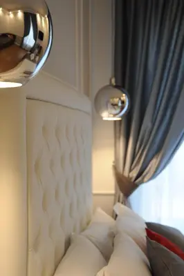 a white couch with pillows in front of a window at My Suites Piazza di Spagna in Rome