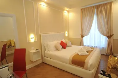 a bedroom with a large white bed with a window at My Suites Piazza di Spagna in Rome