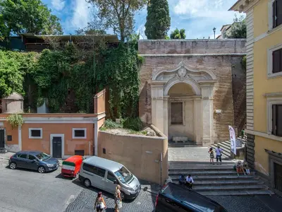 a building with cars parked in a parking lot at My Suites Piazza di Spagna in Rome