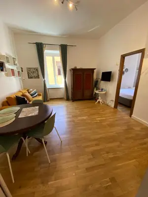 a living room with a table and a couch at La casa di Remo in Rome