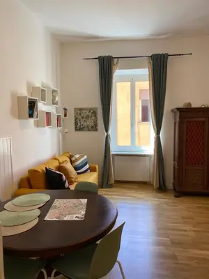 a living room with a table and a couch at La casa di Remo in Rome