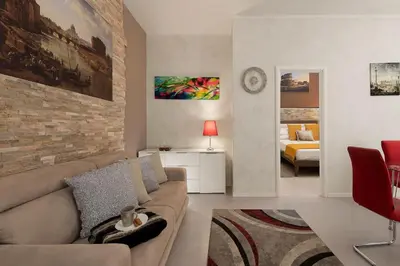 a living room with a couch and a brick wall at GuestHouse near St.Peter in Rome