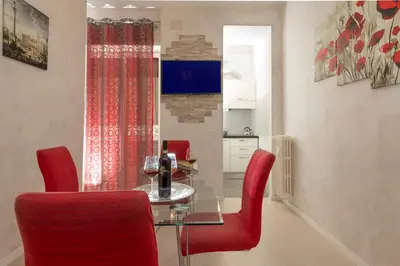 a dining room with red chairs and a glass table at GuestHouse near St.Peter in Rome