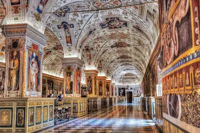a large room with paintings on the walls of a building at GuestHouse near St.Peter in Rome