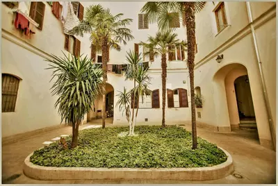 a courtyard with palm trees in a building at Accogliente appartamento a Testaccio in Rome