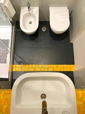 a bathroom with a sink and a tub and a toilet at Viaggio da Bea al Gianicolo in Rome