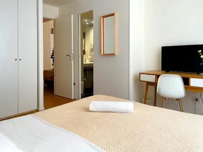 a bedroom with a bed and a desk and a television at Viaggio da Bea al Gianicolo in Rome