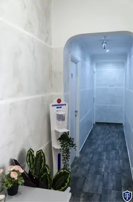 a hallway with a door and plants in a room at TIBURTINA INN GUEST HOUSE in Rome