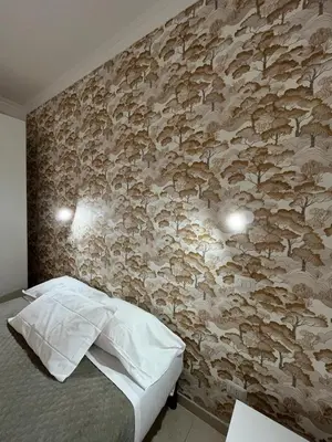 a bedroom with a wall decorated with mushrooms at TIBURTINA INN GUEST HOUSE in Rome