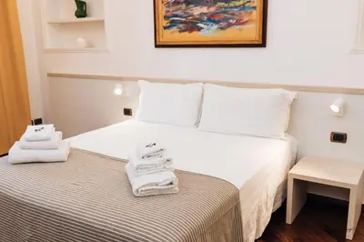 a hotel room with a bed with towels on it at Magik rooms in Rome