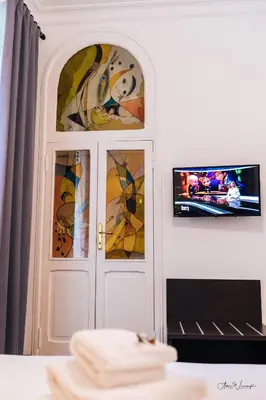 a white door with windows and a tv on a wall at Magik rooms in Rome