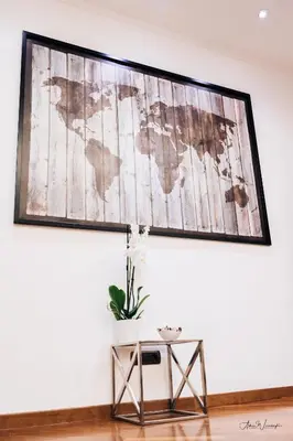 a map of the world hanging on a wall with a table at Magik rooms in Rome