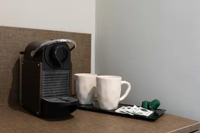 a table with two coffee cups and a microwave at Giubbonari Suites in Rome