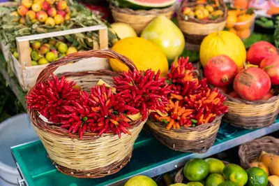 a display of fruits and vegetables in baskets on a table at Giubbonari Suites in Rome