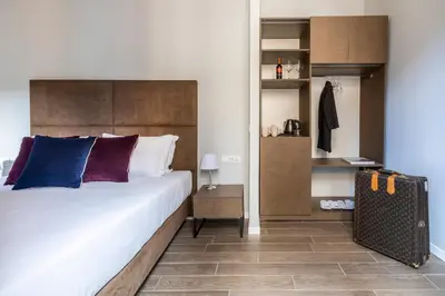 a bedroom with a large bed and a closet at Giubbonari Suites in Rome