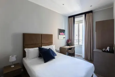 a hotel room with a large bed and a window at Giubbonari Suites in Rome
