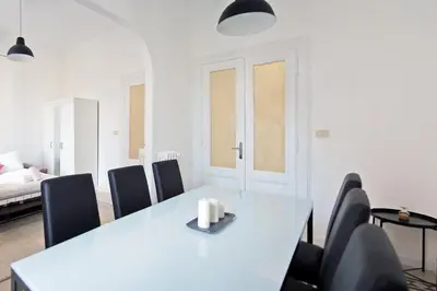 a white dining room with a table and chairs at Guardabassi Collection - Vatican White by Varental in Rome