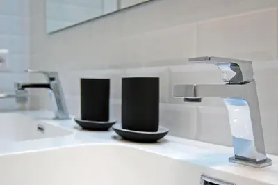 a kitchen counter with two sinks and a faucet at Guardabassi Collection - Vatican White by Varental in Rome