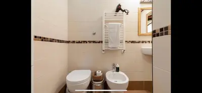a small bathroom with a toilet and a bidet at Center Rome Coliseum in Rome