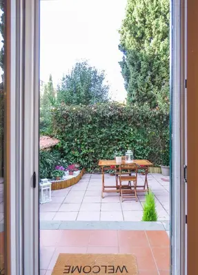 a sliding glass door leading to a patio with a table at Casa Sofia - beauty apartment close Vatican Museum in Rome