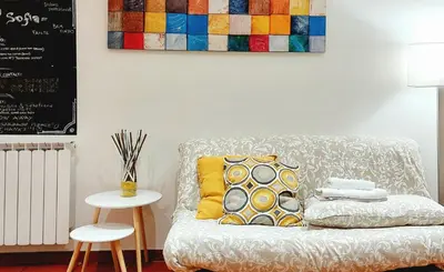 a living room with a couch and a painting on the wall at Casa Sofia - beauty apartment close Vatican Museum in Rome