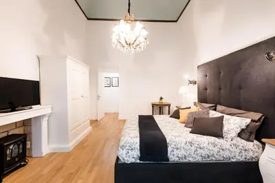a bedroom with a large bed and a chandelier at Casa Prati Michelangelo in Rome