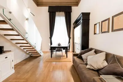 a living room with a couch and a piano at Casa Prati Michelangelo in Rome