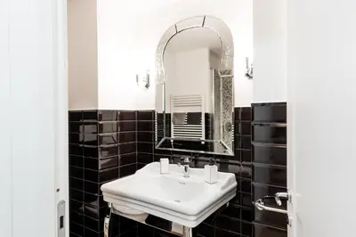 a bathroom with a white sink and a mirror at Casa Prati Michelangelo in Rome