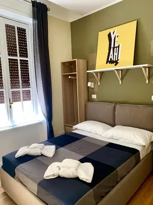 a bedroom with a bed with two towels on it at Frattina Luxury House in Rome