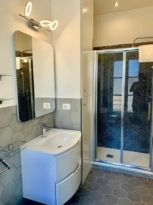 a bathroom with a sink and a shower at Frattina Luxury House in Rome
