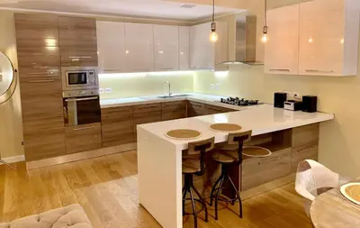 a kitchen with a island with stools in it at Frattina Luxury House in Rome