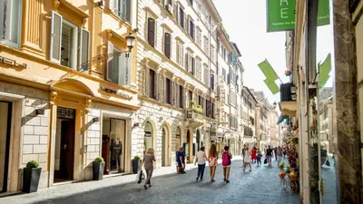 a group of people walking down a street at Frattina Luxury House in Rome