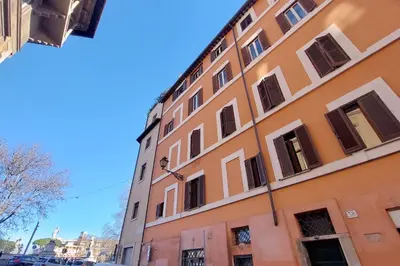 an orange building with windows on a street at Casa dell'Angelo in Rome