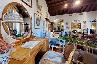 a living room with a table and a mirror at Casa dell'Angelo in Rome