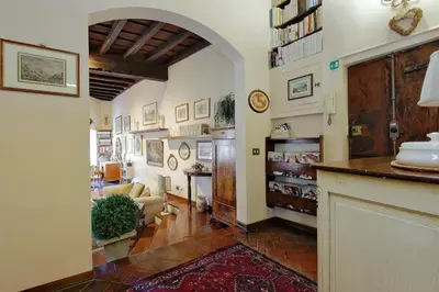 a living room with an archway and a living room with a couch at Casa dell'Angelo in Rome