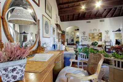 a living room with a table and a mirror at Casa dell'Angelo in Rome