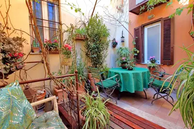 a patio with a table and chairs and plants at Casa dell'Angelo in Rome