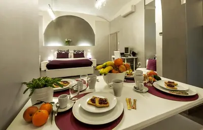 a room with a table with plates of food on it at Casa Calpurnia in Rome