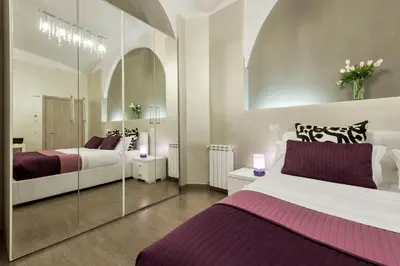 a bedroom with two beds and a glass wall at Casa Calpurnia in Rome