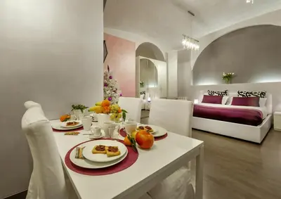 a room with a table with food and a bed at Casa Calpurnia in Rome