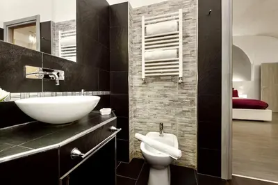 a bathroom with a white sink and a toilet at Casa Calpurnia in Rome