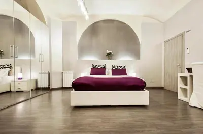 a bedroom with a large bed with purple sheets at Casa Calpurnia in Rome