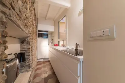 a kitchen with a sink and a stone wall at Campo De' Fiori Apartment - Charme Holidays in Rome